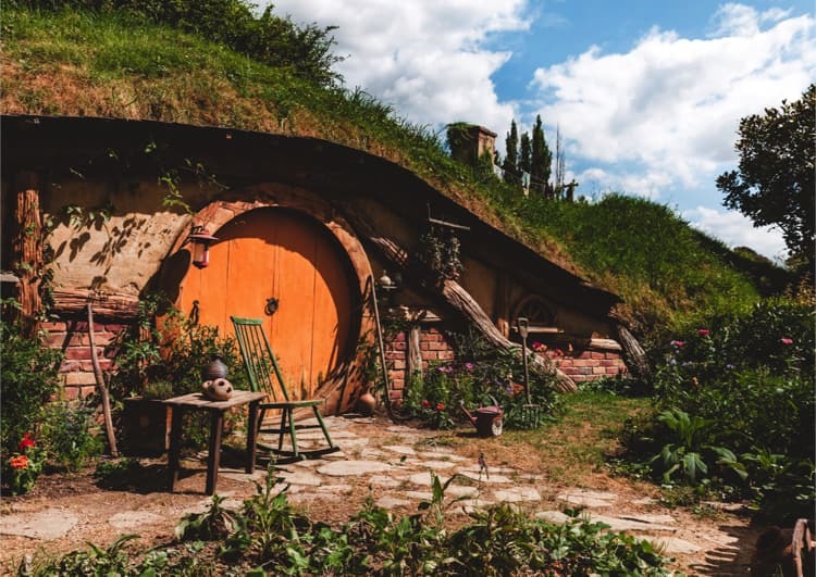 grass roof hobbit-style house with round door